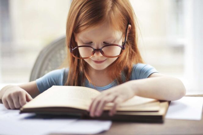 criança lendo livro